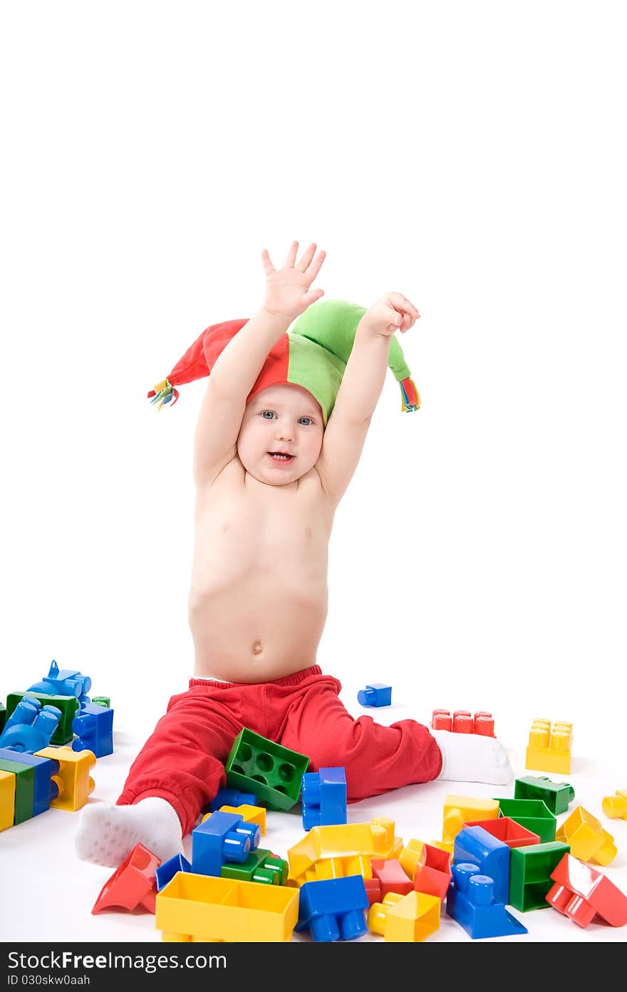 Baby with block is playing on the ground