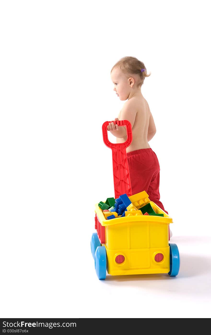 Little girl is sitting on the floor and playing with blocks. Little girl is sitting on the floor and playing with blocks