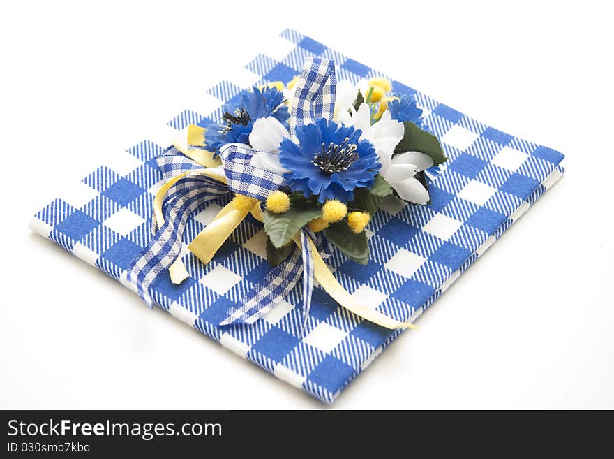 Blue flower jewelry onto blue-white table cloth