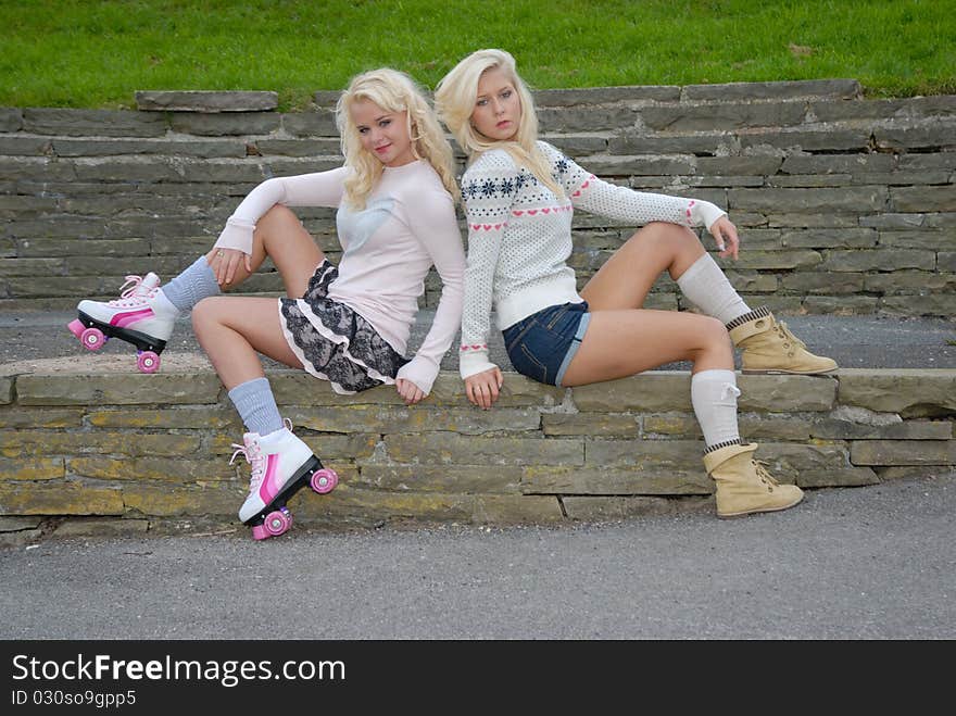 Photograph of two pretty young women on skates. Photograph of two pretty young women on skates