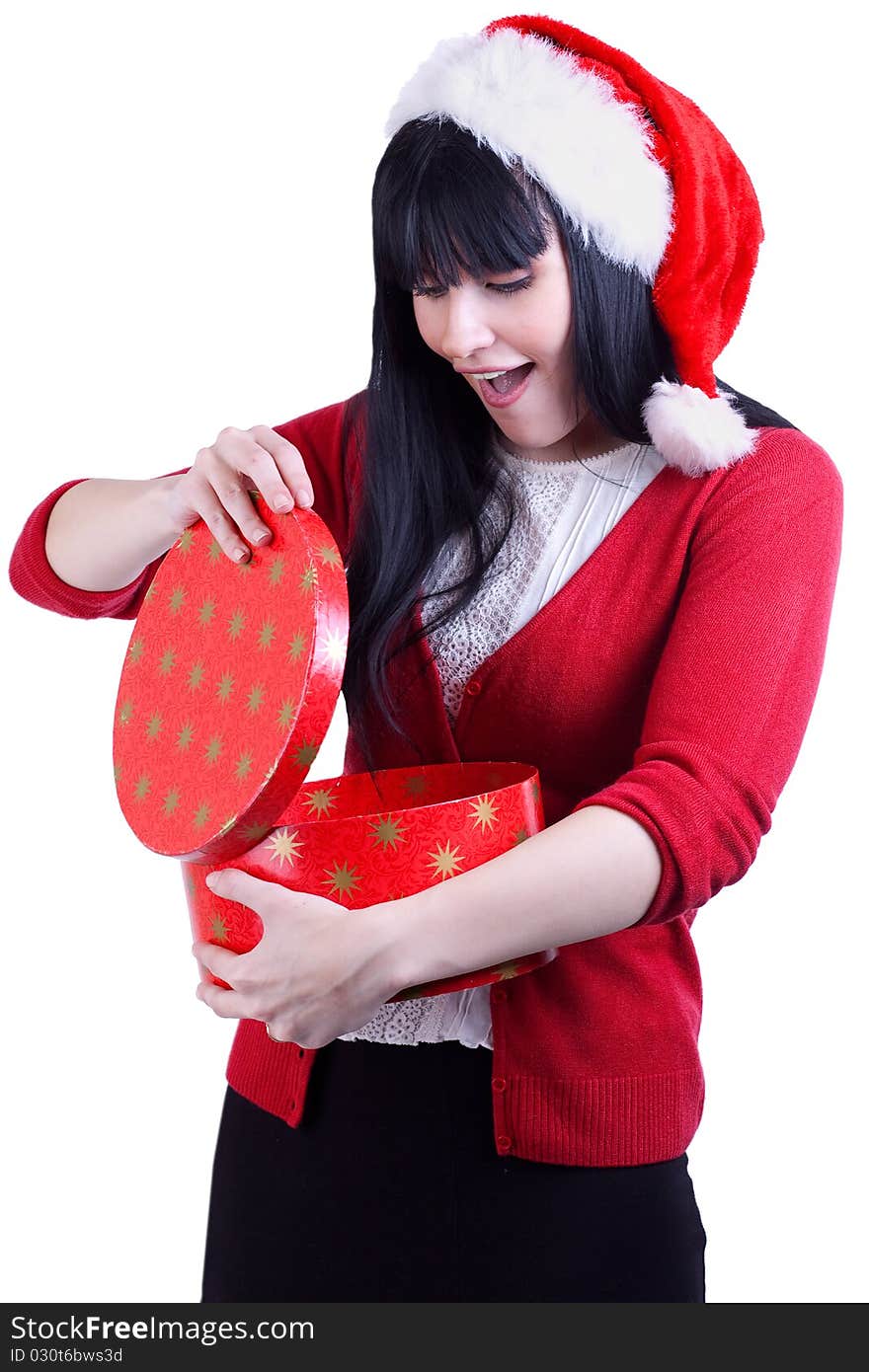 Pretty girl in red hat opens box with gift on white. Pretty girl in red hat opens box with gift on white