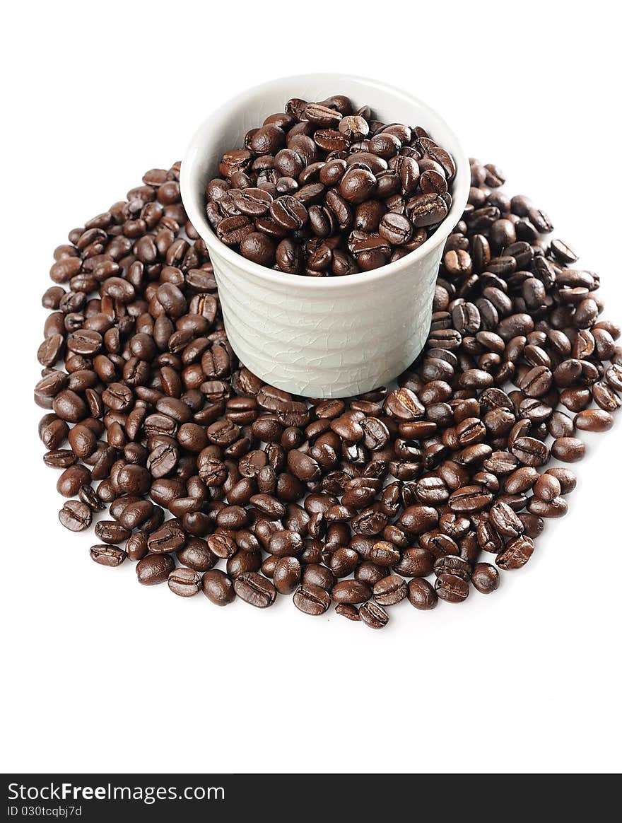 Coffee beans in a cup on white background