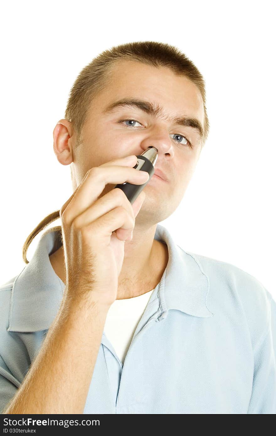 Young man with machine shaves off her hair in the nose. Isolated on a white background. Young man with machine shaves off her hair in the nose. Isolated on a white background