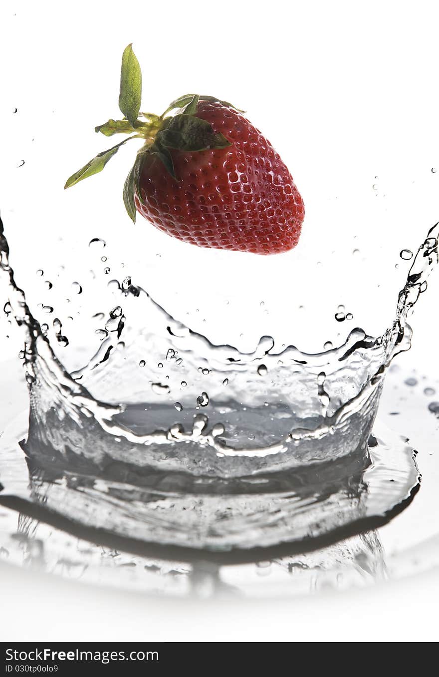 Fruits falling in water on white background