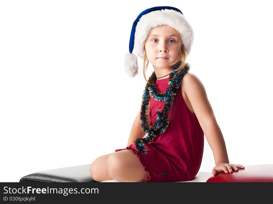 Girl in Santa'sblue hat and tinsel isolated on white. Girl in Santa'sblue hat and tinsel isolated on white