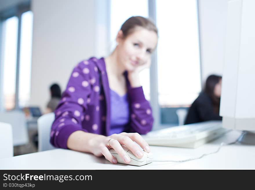 Pretty young college student in a library (shallow DOF; color toned image)