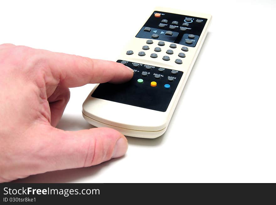 Human hand with TV remote control over white background