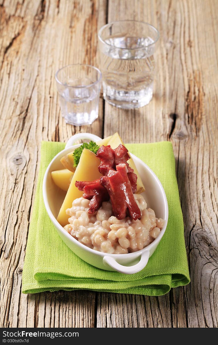 White beans, potatoes and roasted sausages - closeup. White beans, potatoes and roasted sausages - closeup