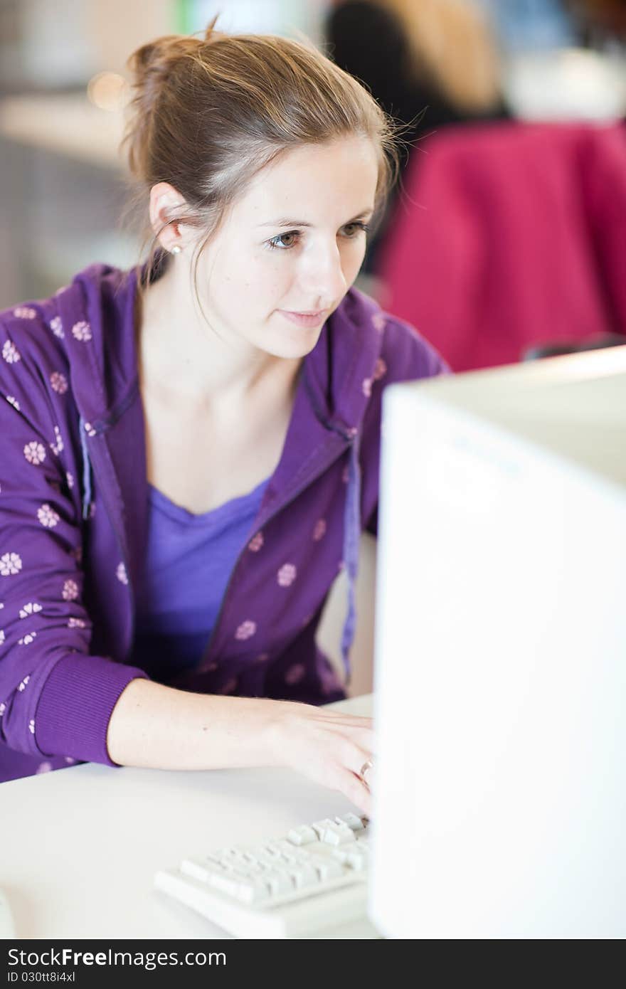 Pretty young college student in a library (shallow DOF; color toned image)