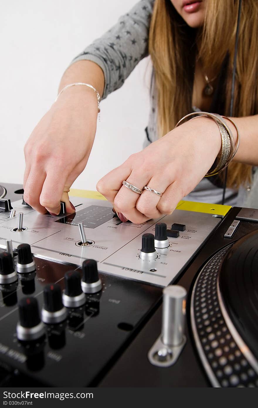 Hands of a disc jockey girl playing music from vinyl. Hands of a disc jockey girl playing music from vinyl