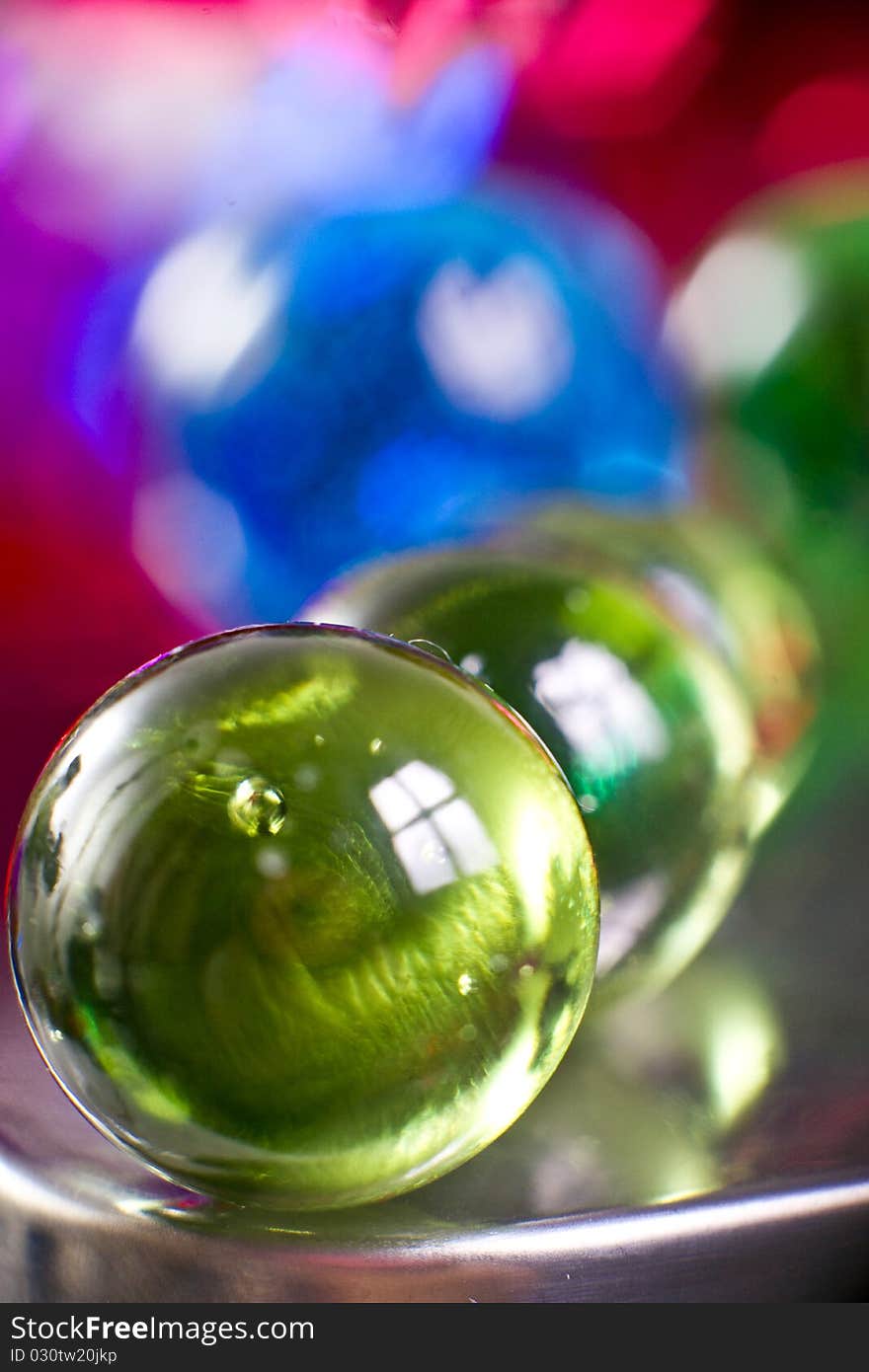 Marbles on colorfull blurred background