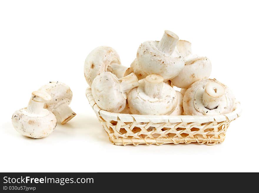 Mushrooms champignon in wooden basket