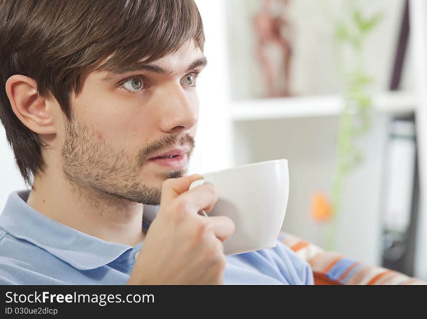 Man drinking tea and watching television