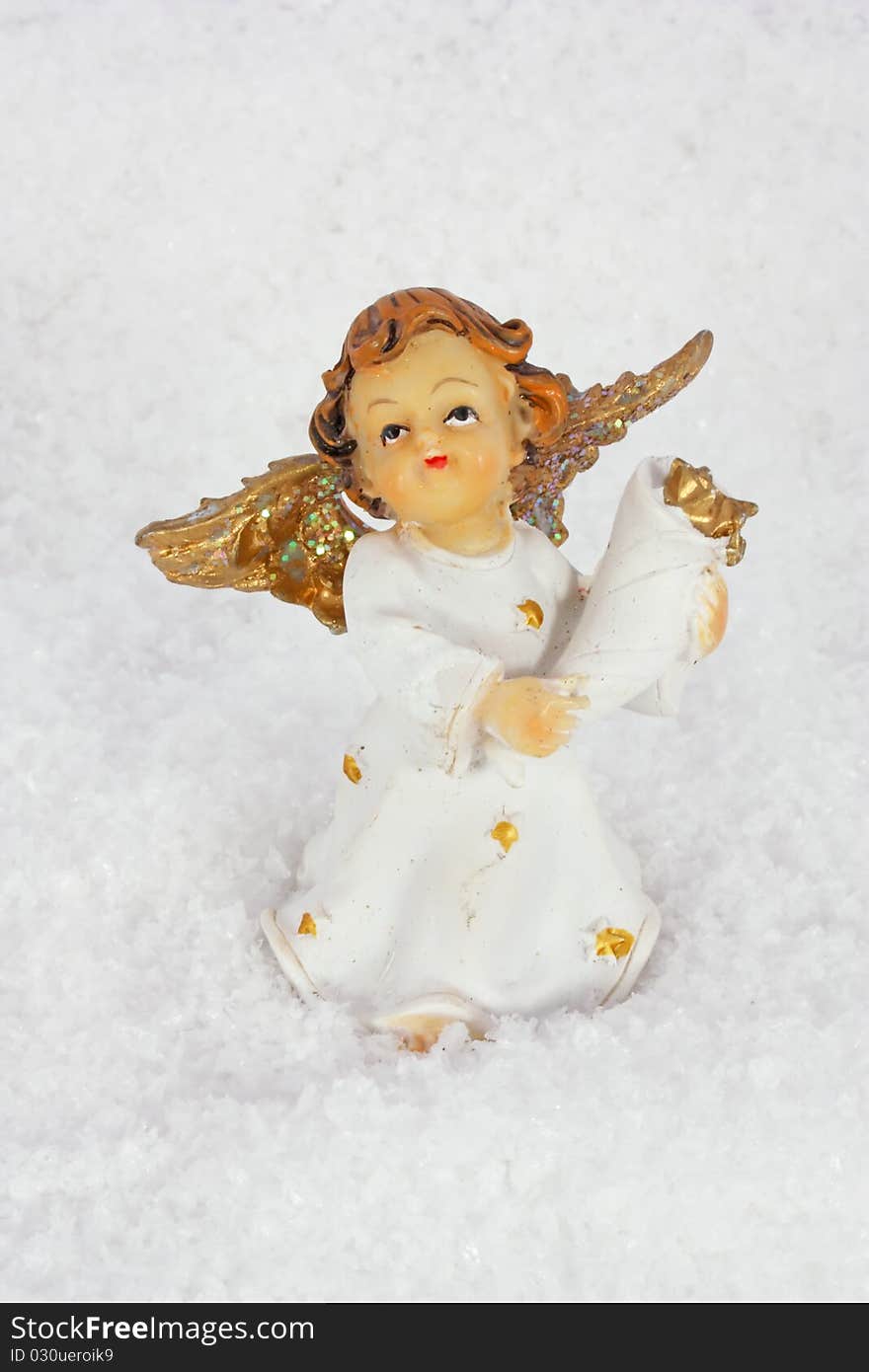 Little angel in artificial snow christmas decoration. Little angel in artificial snow christmas decoration