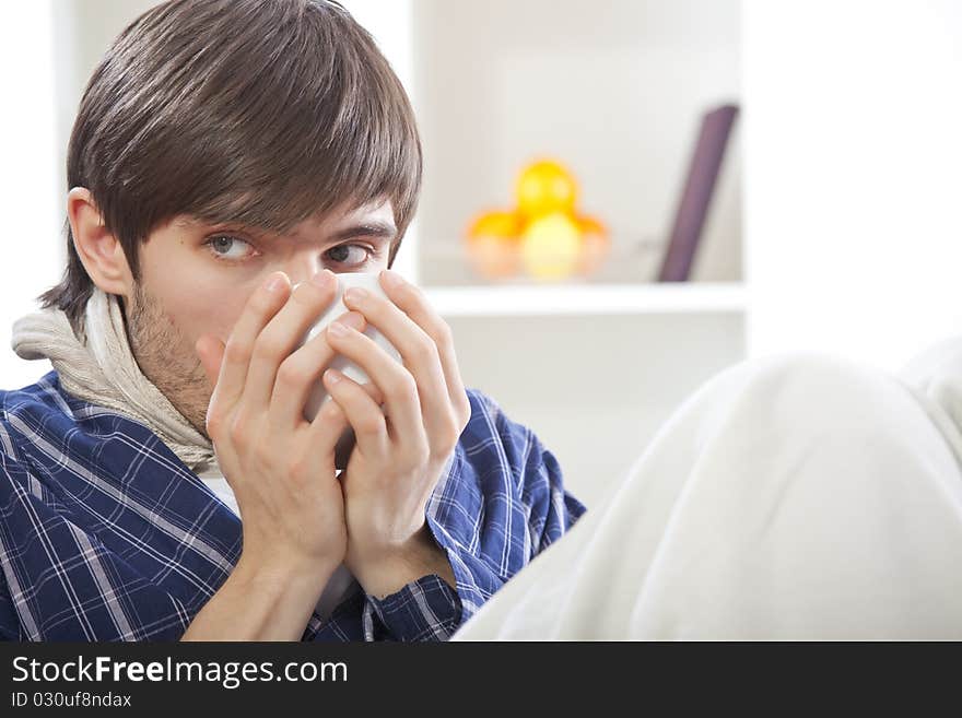 Sick man in bed drinking hot tea at home. Sick man in bed drinking hot tea at home