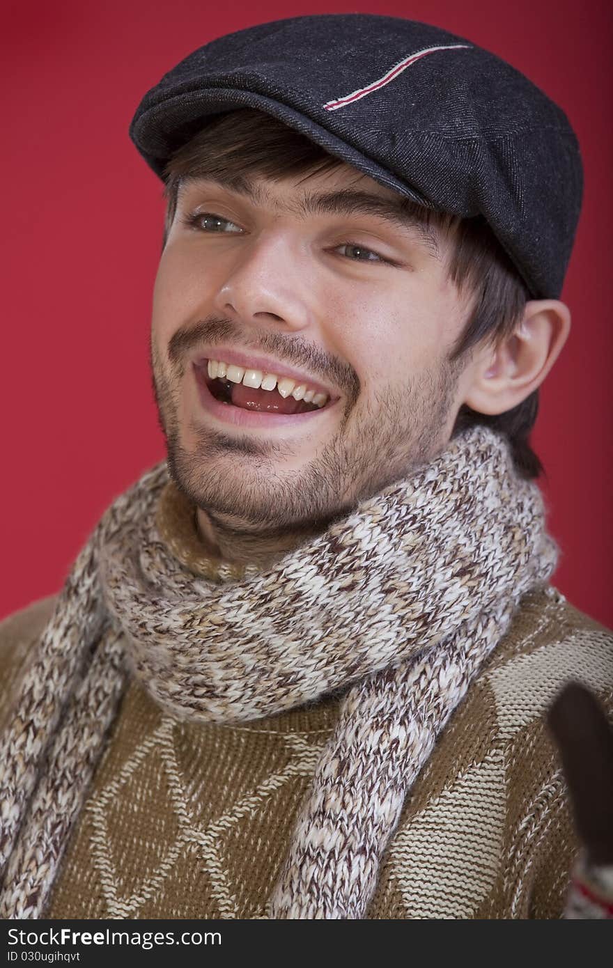 Portrait of laughing man on red background