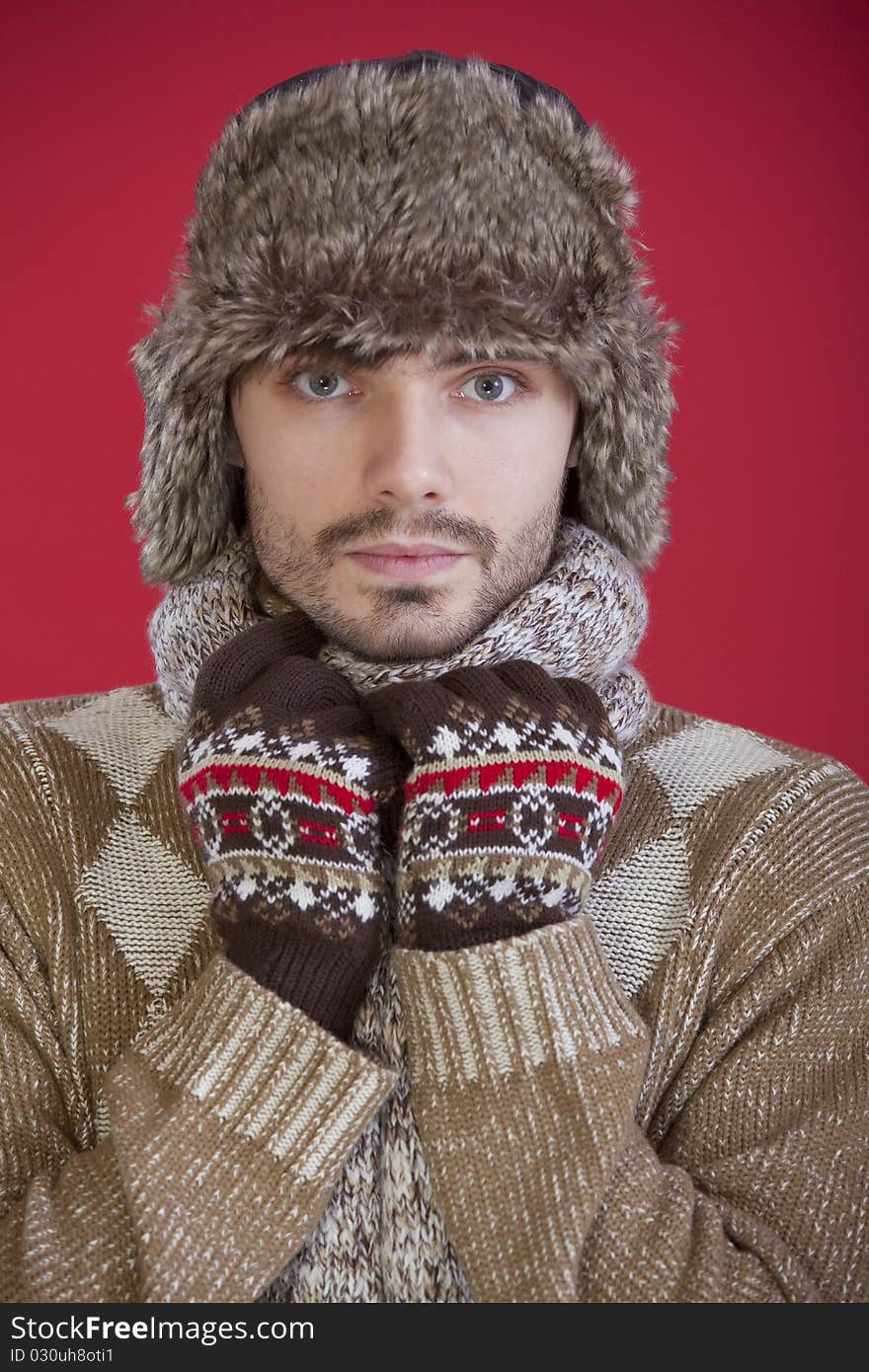 Portrait of man in fur winter hat and sweater. Portrait of man in fur winter hat and sweater