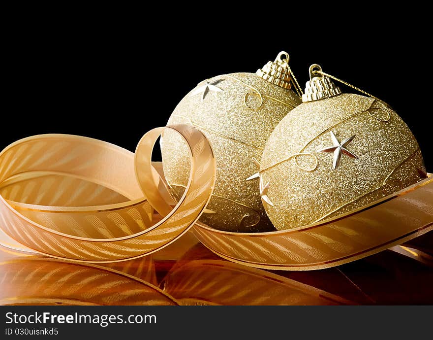 Two christmas balls with ribbon,black background