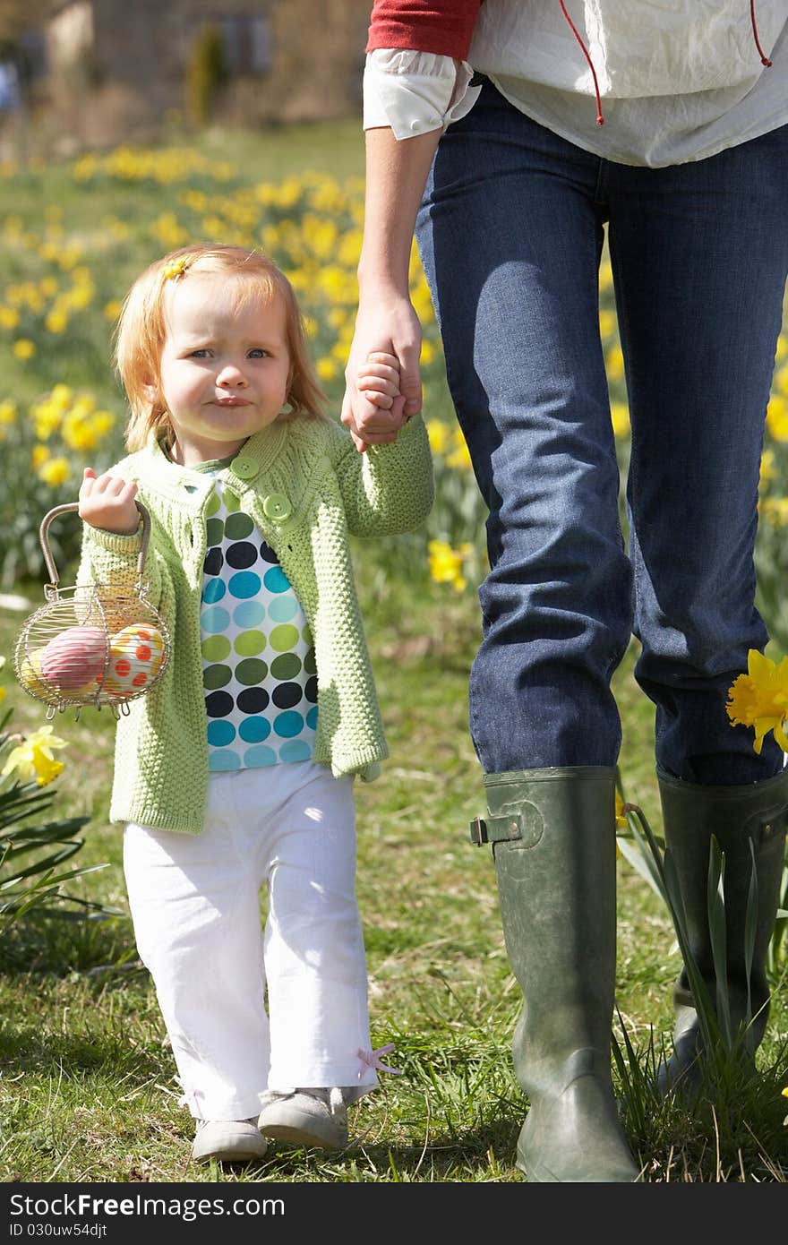 Mother And Daughter In Daffodil Field With Decorated Easter Eggs. Mother And Daughter In Daffodil Field With Decorated Easter Eggs