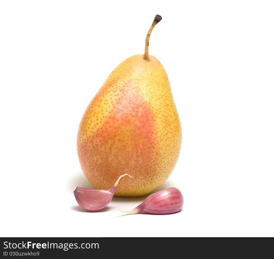 Pear and two segments of garlic on a white background. Pear and two segments of garlic on a white background.