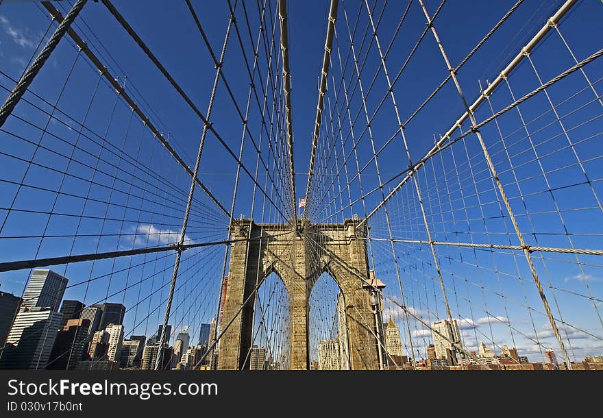 The Brooklyn Bridge with the Brooklyn skyline in the background.