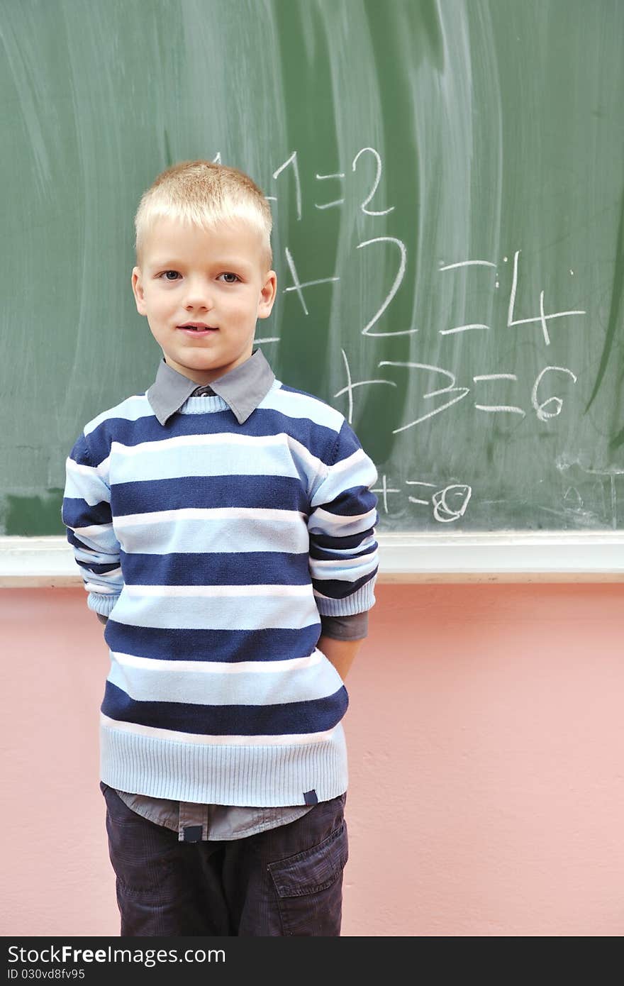 Happy young boy at first grade math classes solving problems and finding solutions