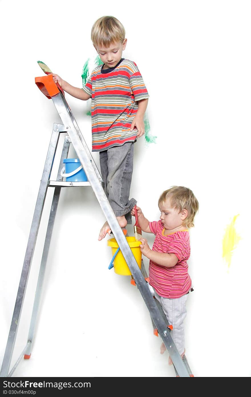 Two children painting over white