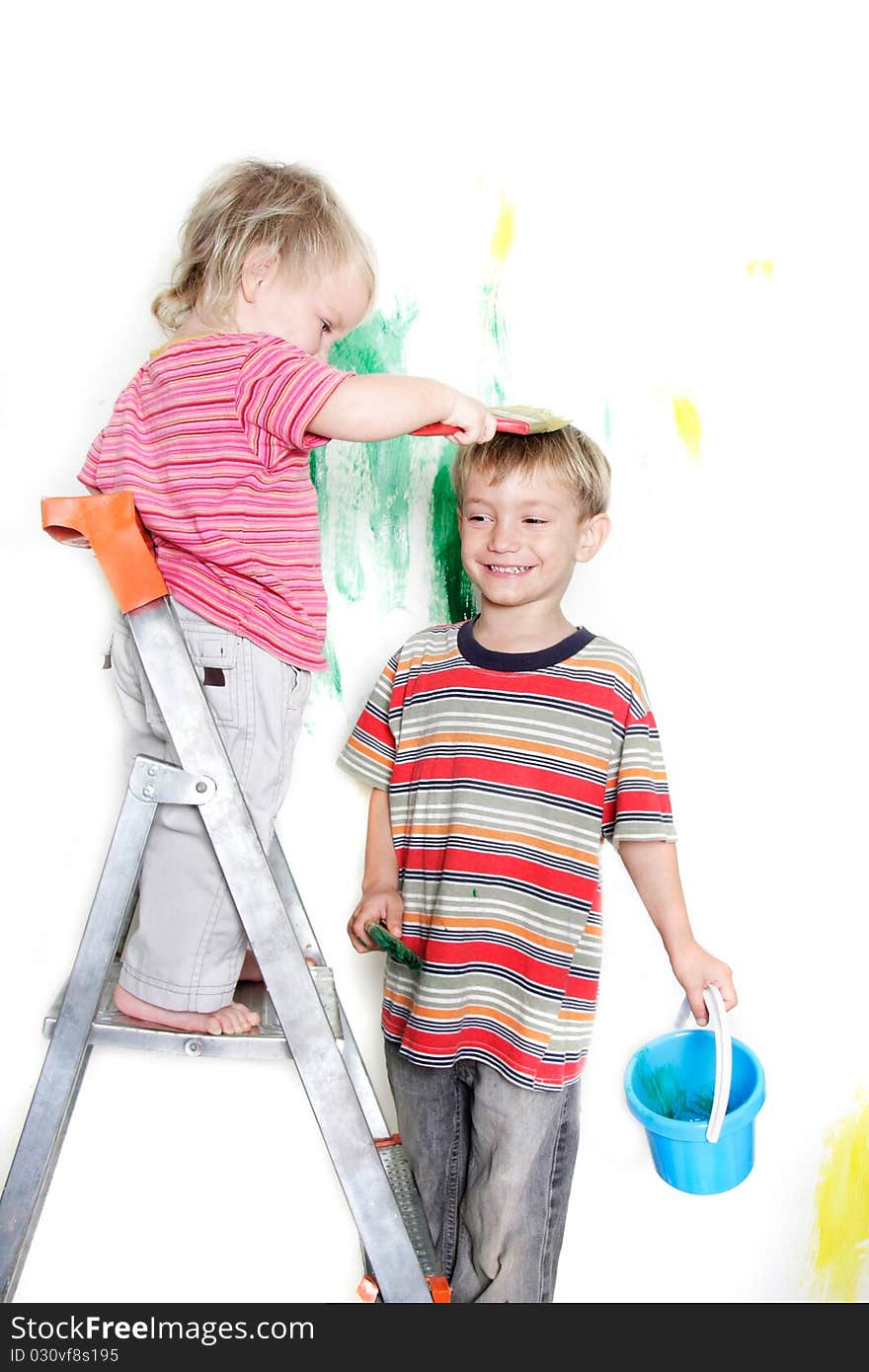 Two children painting over white