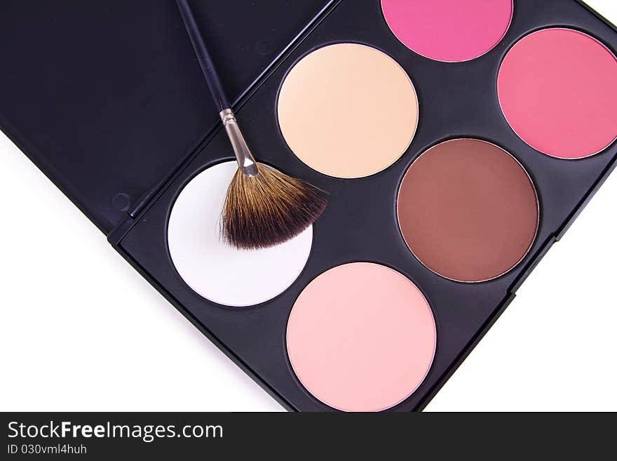 Professional make-up brush on eyeshadows palette, closed-up