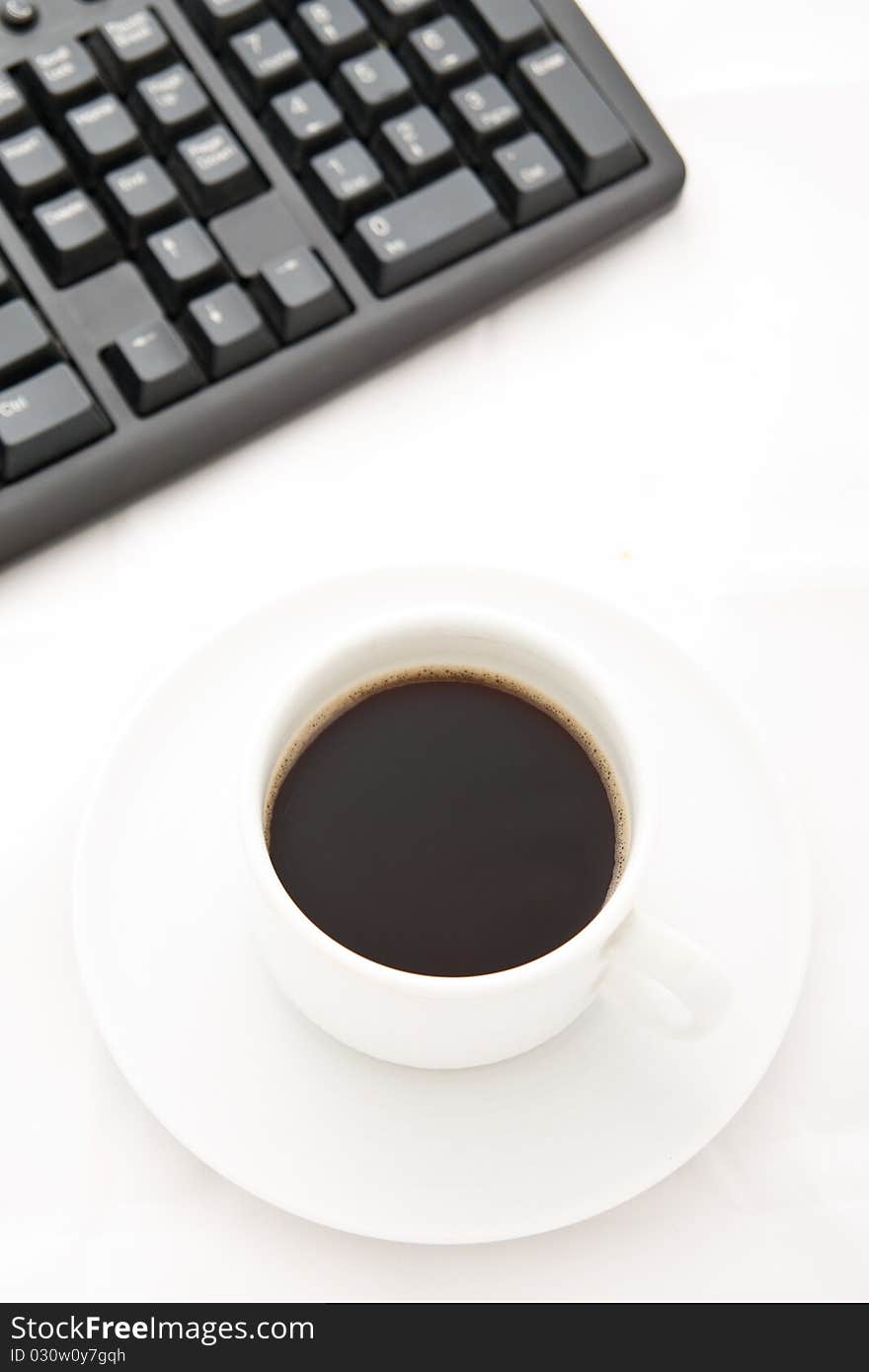 White coffee cup and black keyboard