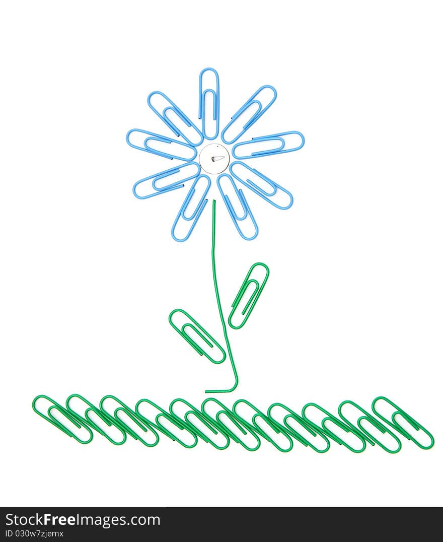 Beautiful flower on a grass from office paper clips for a paper. Beautiful flower on a grass from office paper clips for a paper