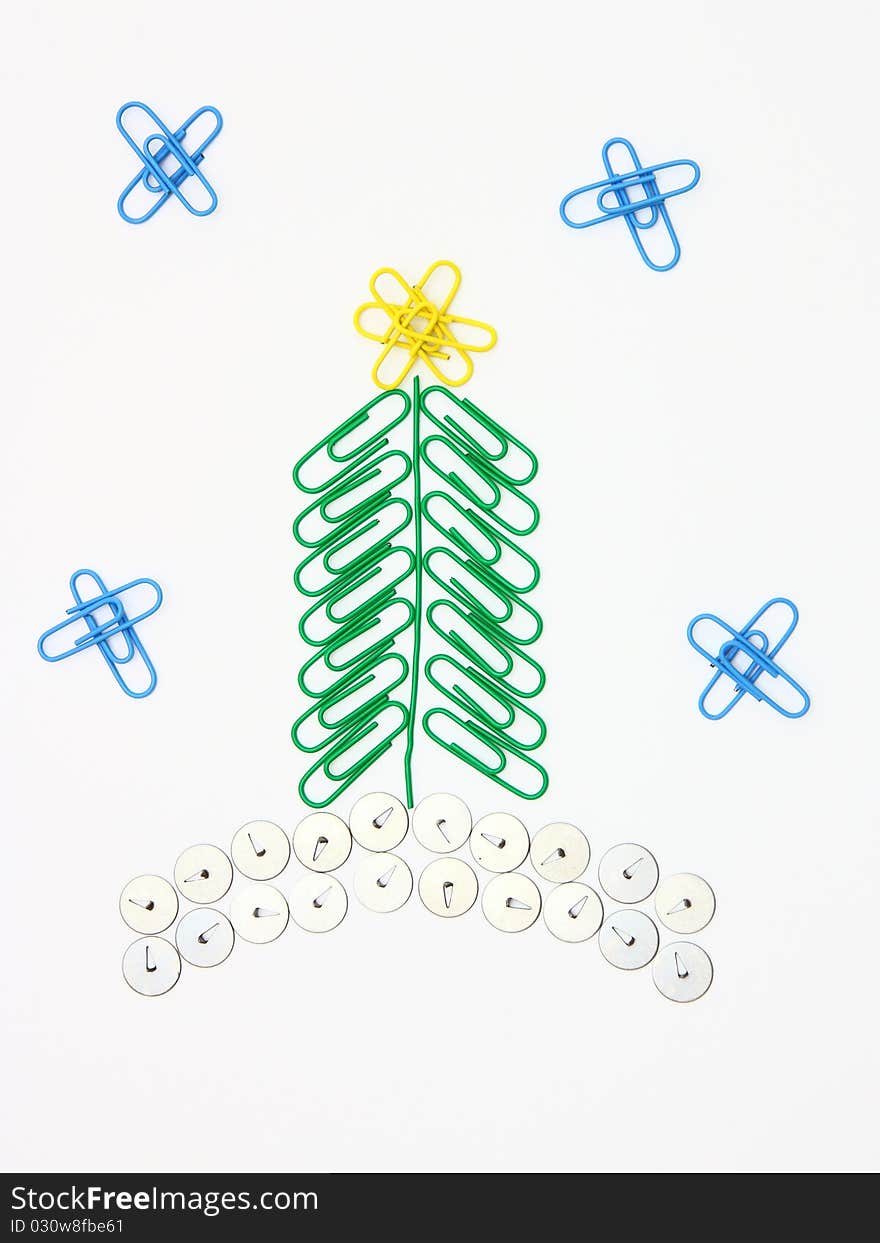 Christmas fur-tree from paper clips for a paper on a white background. Christmas fur-tree from paper clips for a paper on a white background