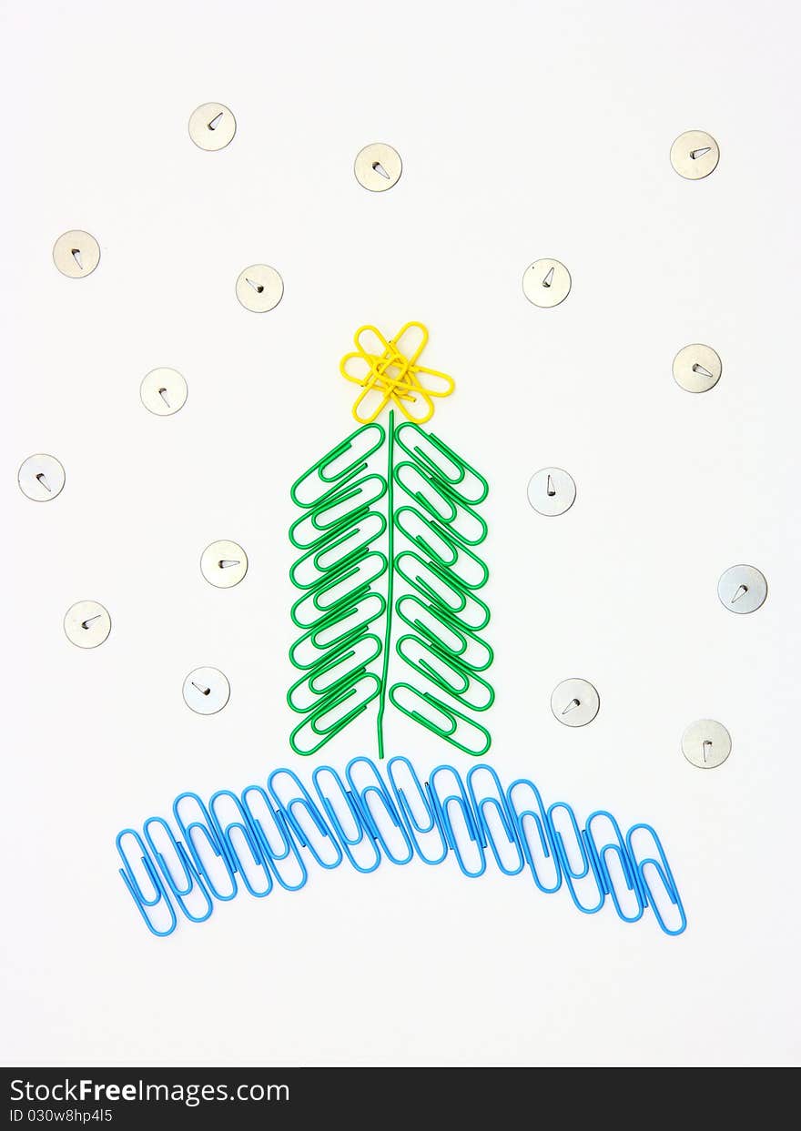 Christmas fur-tree from paper clips for a paper on a white background. Christmas fur-tree from paper clips for a paper on a white background