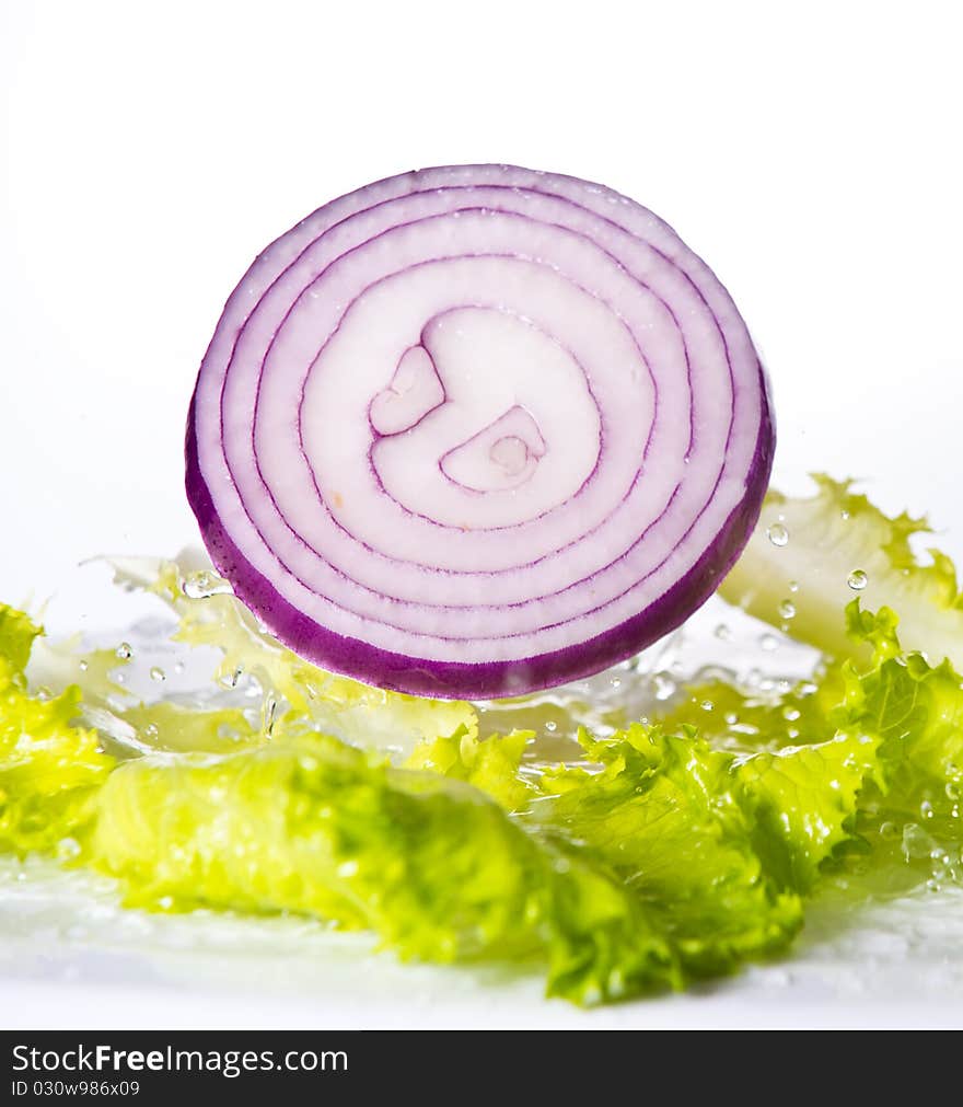 Onion falling into a salad