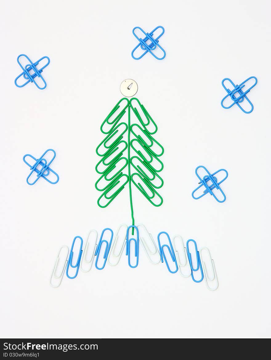 Christmas fur-tree from paper clips for a paper on a white background. Christmas fur-tree from paper clips for a paper on a white background