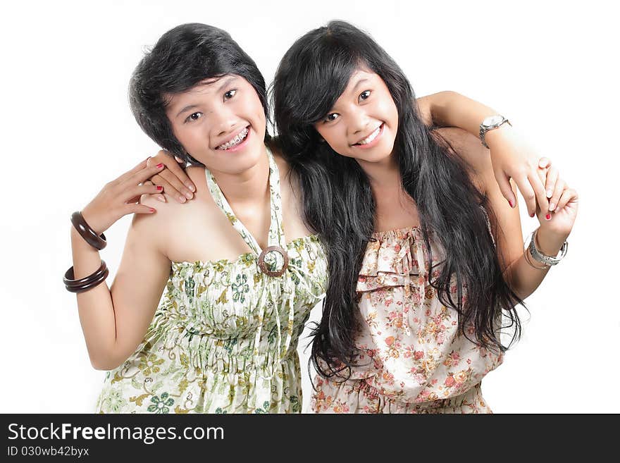 Two girl best friends smiling over white background