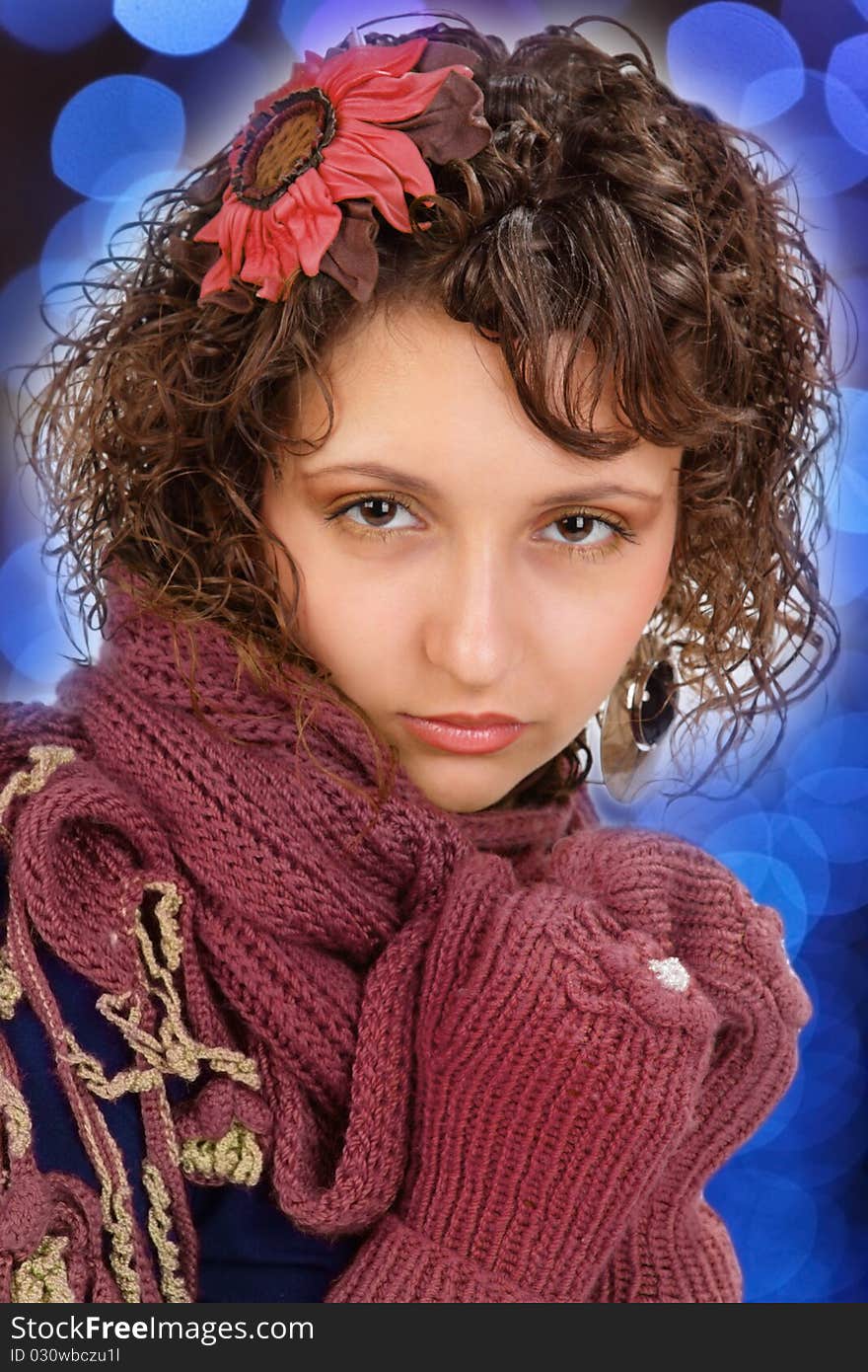 The fine young girl with a brown, cold scarf on a white background. The fine young girl with a brown, cold scarf on a white background