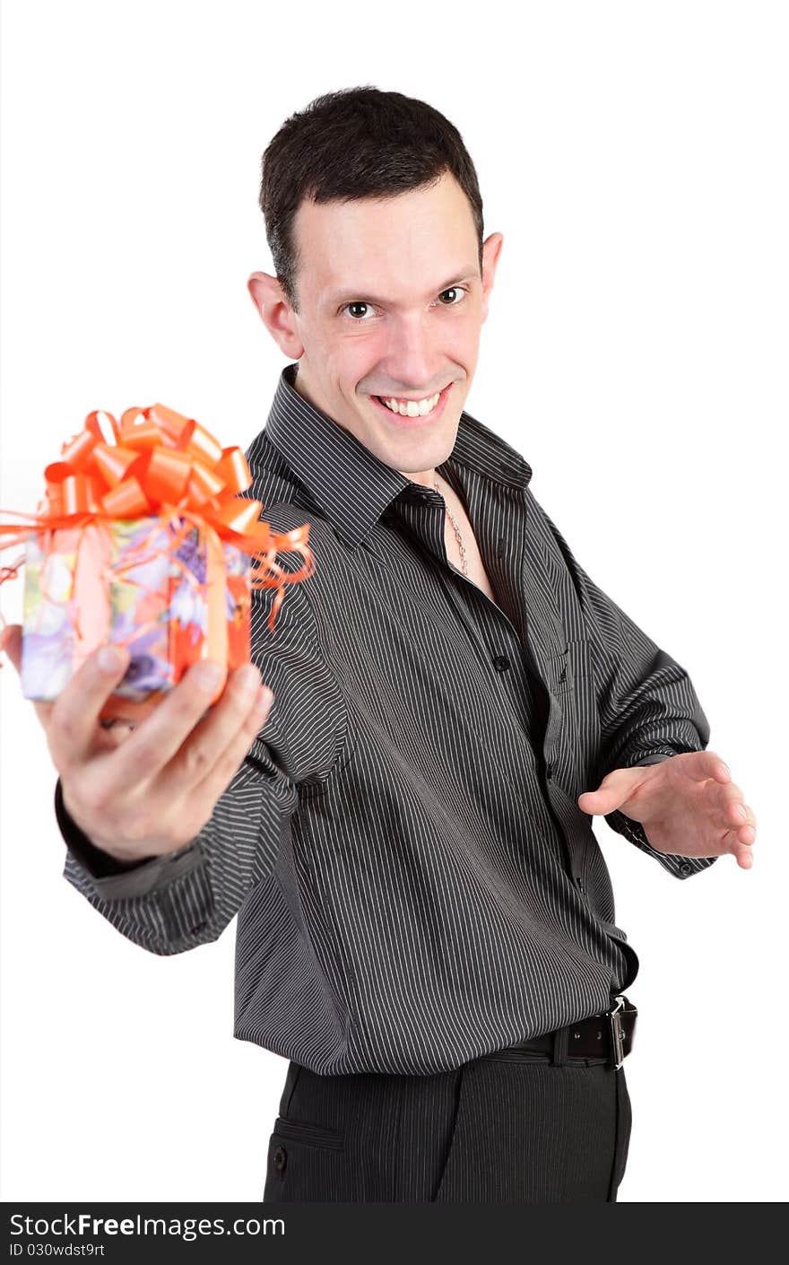 The young smiling guy in a black shirt gives a gift. The young smiling guy in a black shirt gives a gift