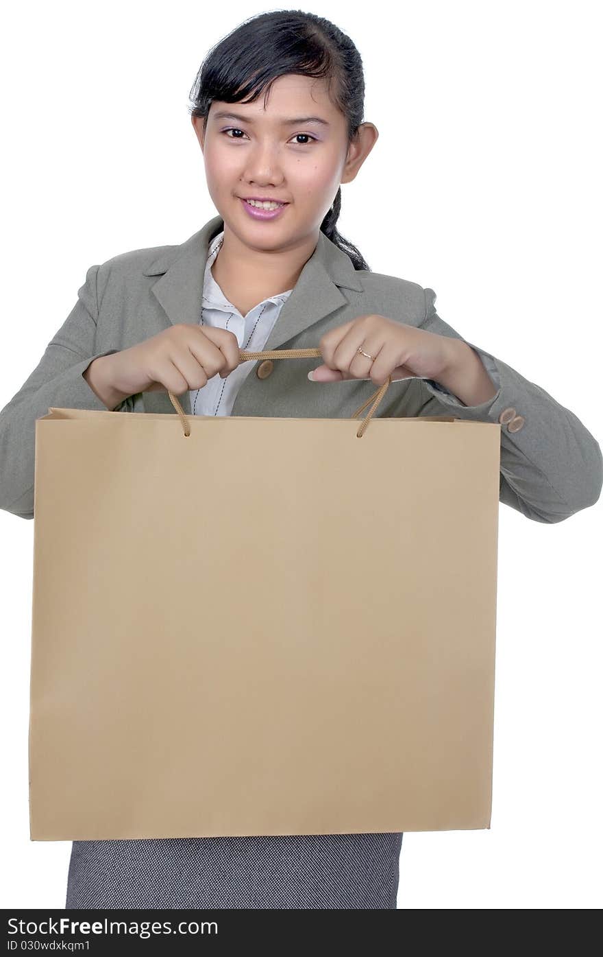 Asian woman holding shopping bag isolated over white background. Asian woman holding shopping bag isolated over white background