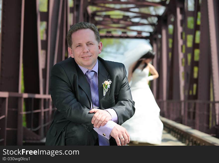 Groom and the bride on the railway bridge. Groom and the bride on the railway bridge