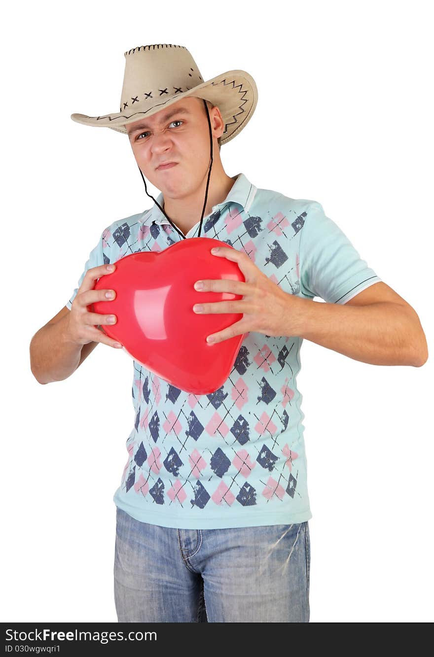 A young beautiful slender fellow in a cowboy hat gets on the hip an air ballon-heart. A young beautiful slender fellow in a cowboy hat gets on the hip an air ballon-heart