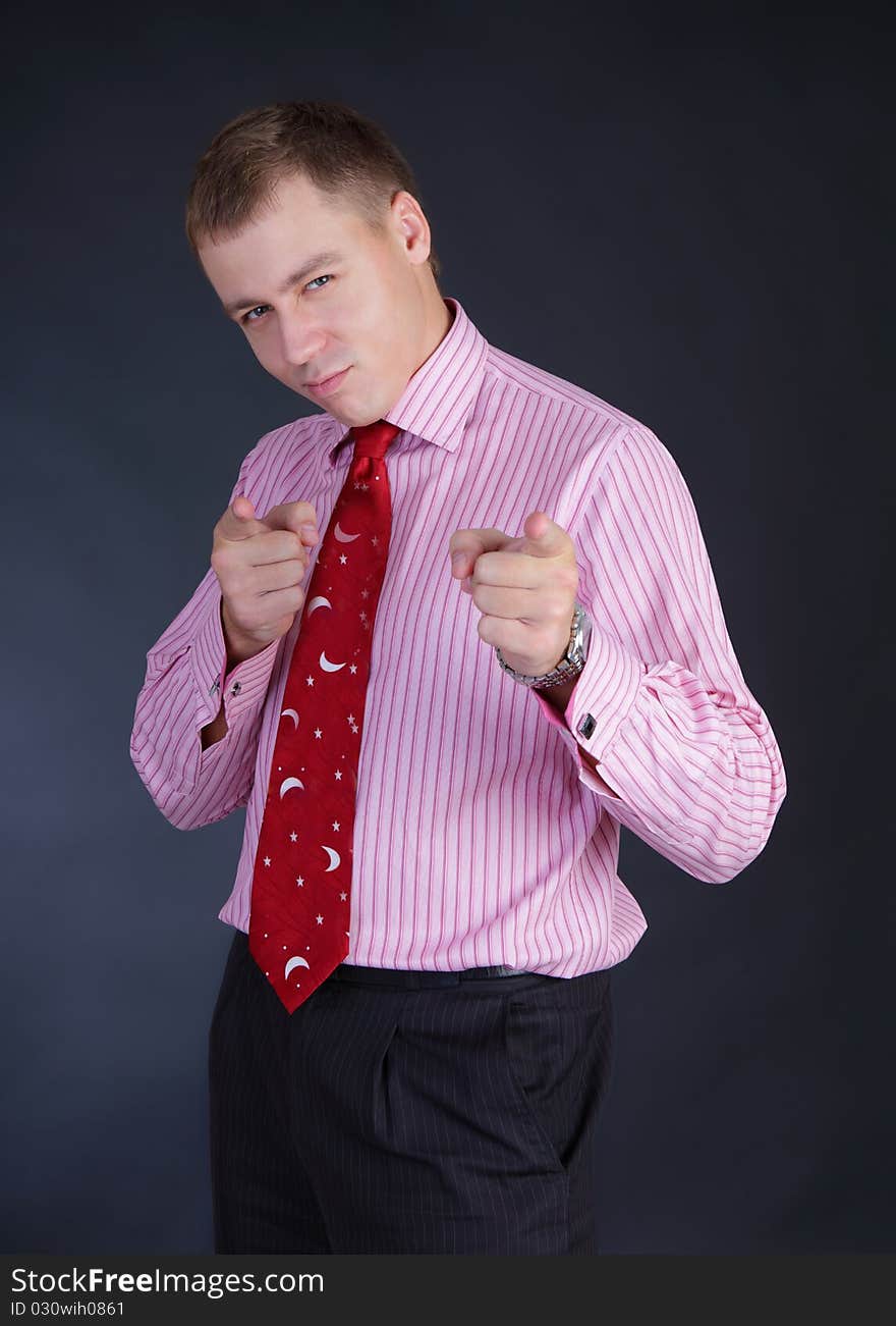 Slender beautiful young fellow in a shirt with a tie in a studio. Slender beautiful young fellow in a shirt with a tie in a studio