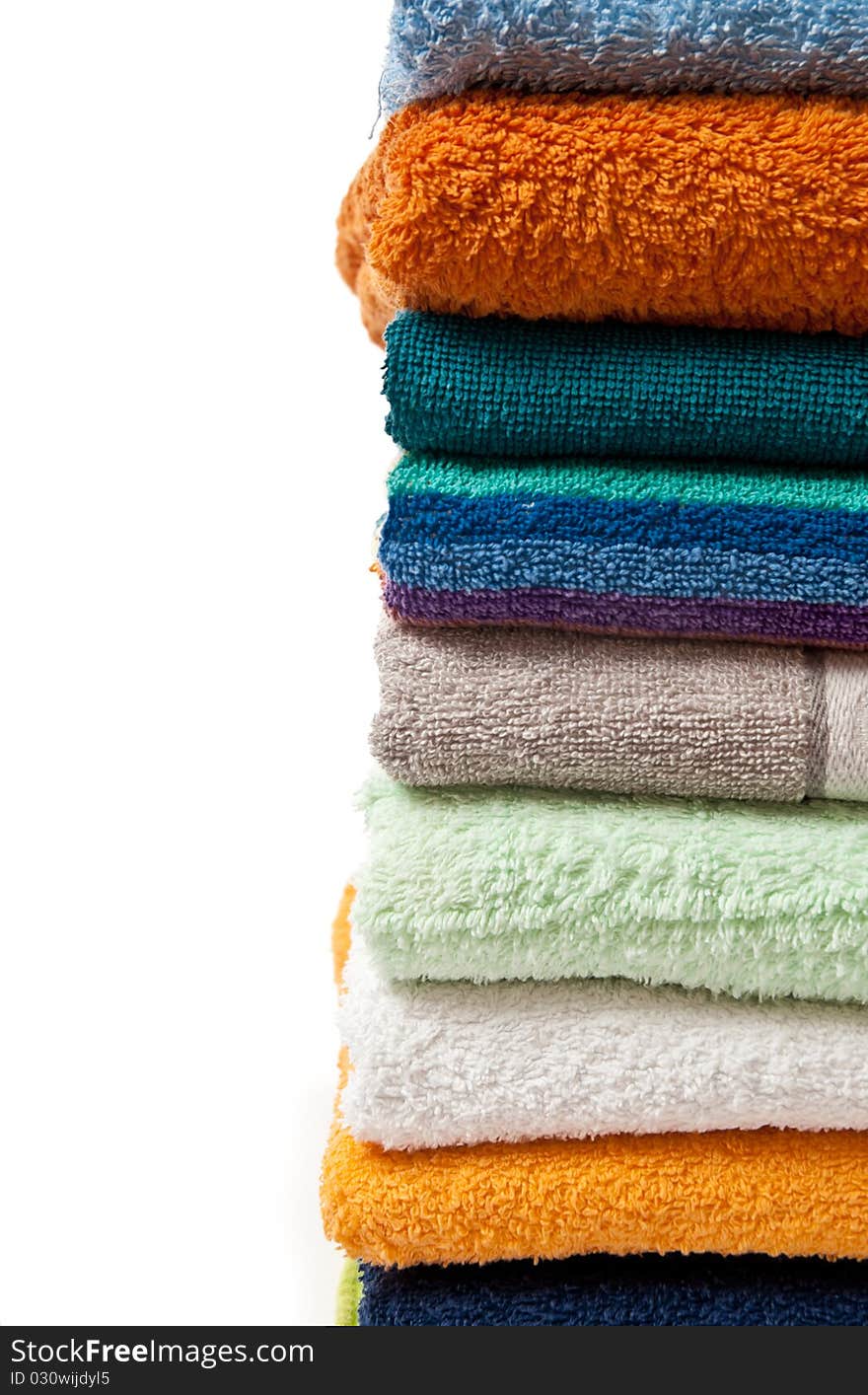 Pile of bright color towels isolated on withe background. Pile of bright color towels isolated on withe background