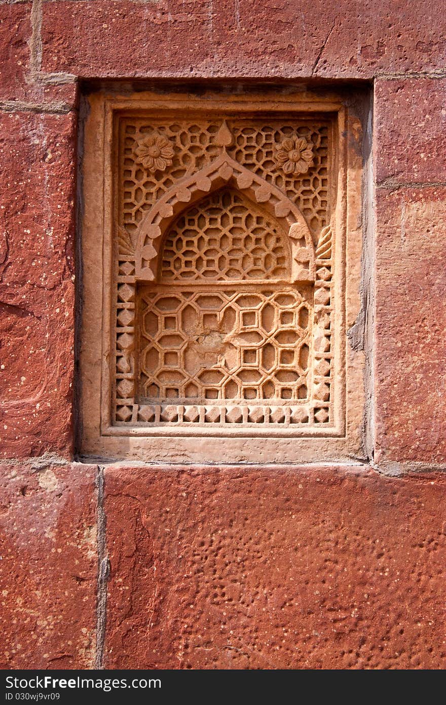 Old ornament on the decorative stone window on the wall. Old ornament on the decorative stone window on the wall