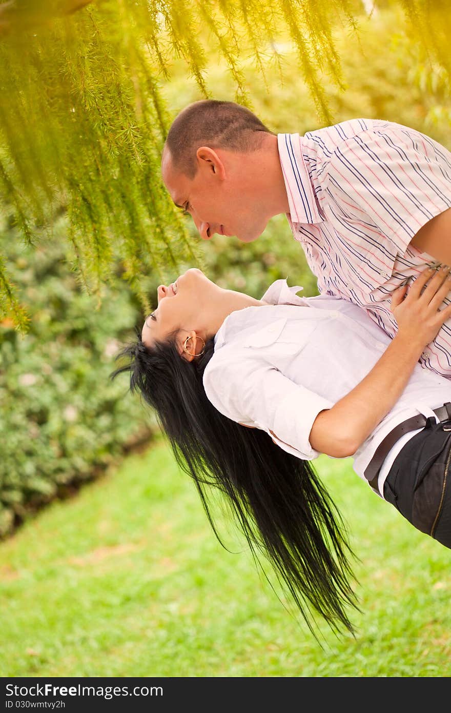 Young lovely couple walking in the park