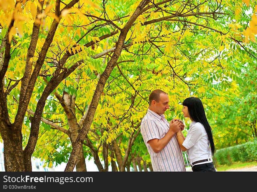 Young lovely couple walking in the park