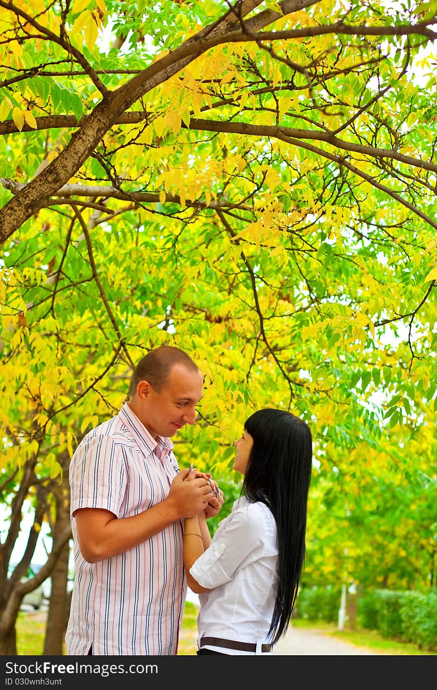 Young lovely couple walking in the park