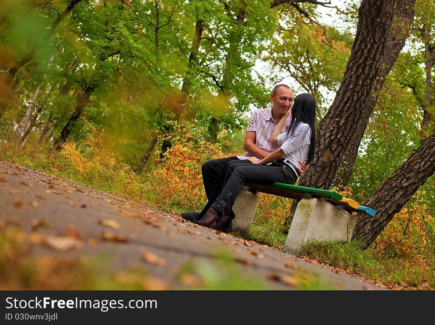 Young lovely couple sitting in the park