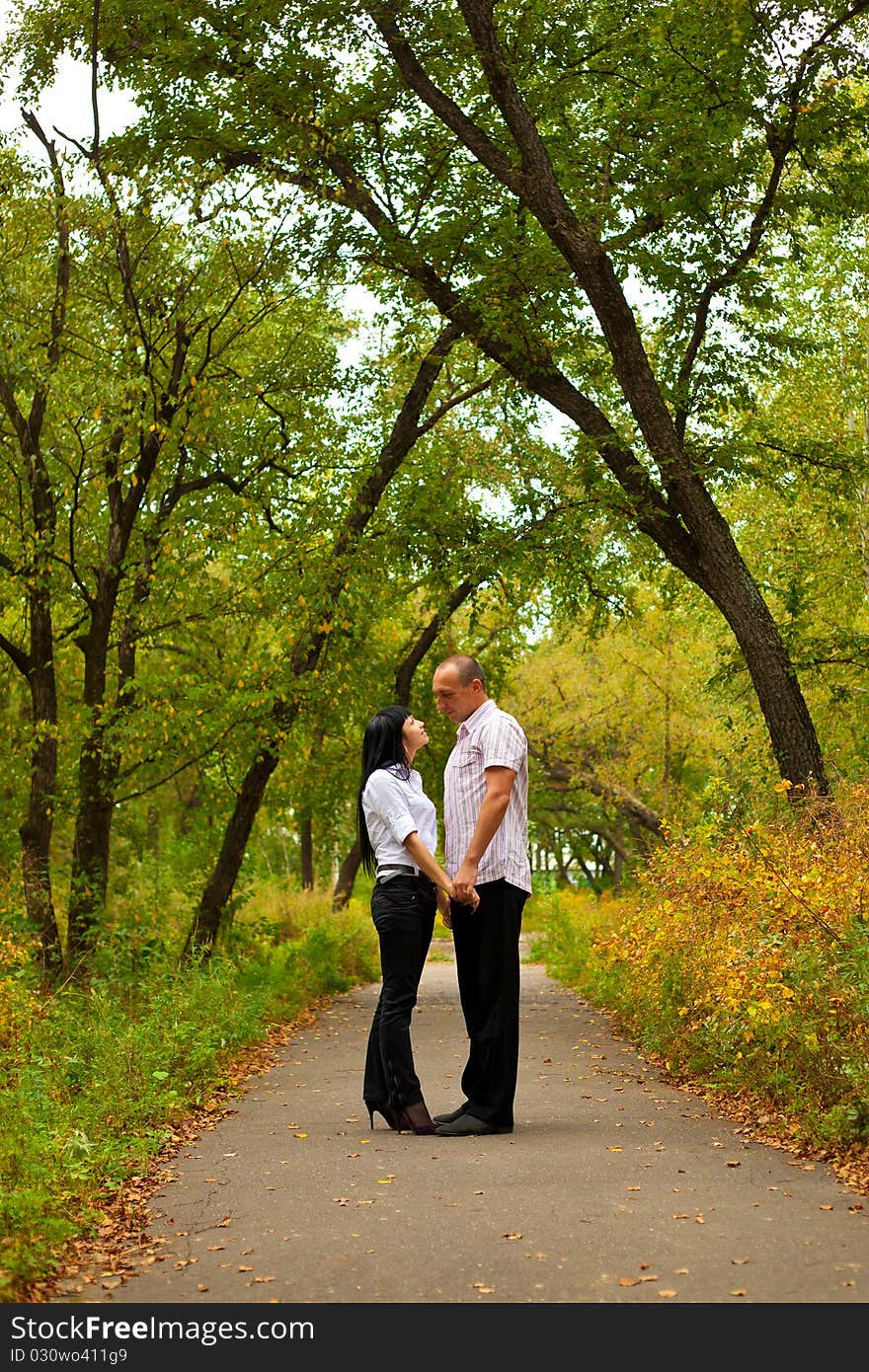 Young lovely couple walking in the park