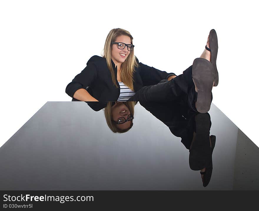 Young blonde buisiness model sitting at a black table. Young blonde buisiness model sitting at a black table